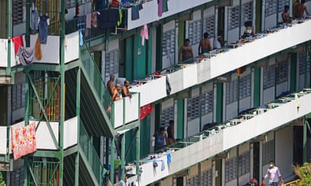 Foreign workers are seen outside their dormitory rooms at Cochrane Lodge II in Singapore