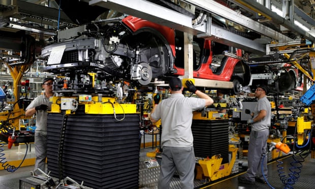 Workers are seen on the production line at Nissan’s car plant in Sunderland Britain