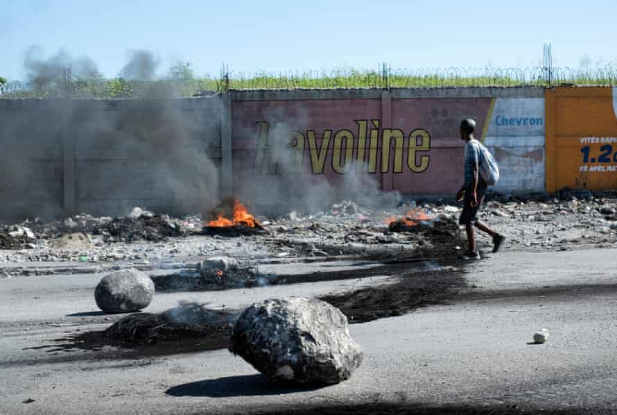 Rocks and burning tyres block a road running alongside the boundary wall of Port-au-Prince’s main airport during anti-government protests in Haiti