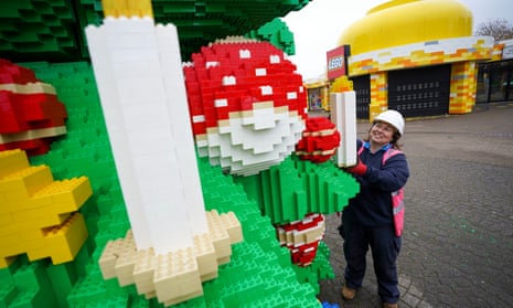 Chief model maker Paula Laughton puts the finishing touches to a Lego Christmas tree at the Legoland theme park in Berkshire, UK. 