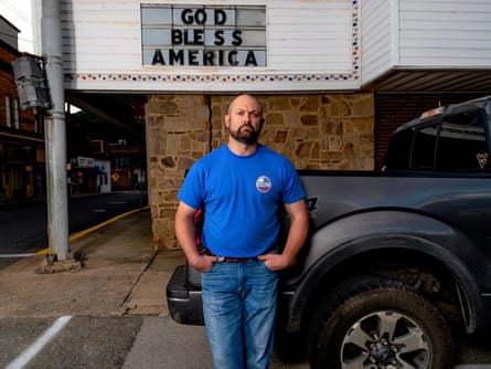a man leans on a car