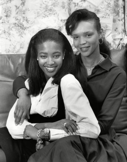 Naomi Campbell on a leather sofa with her mother, Valerie Morris, who has her arm around her daughter.