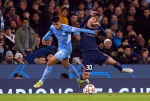 Manchester City’s Joao Cancelo fouls Paris St Germain’s Lionel Messi.