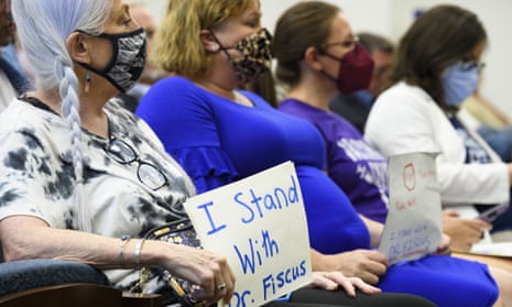 Vaccine advocates display signs in support of Michelle Fiscus at a state legislative committee meeting, 21 July, in Nashville.