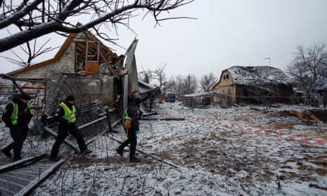 Police officers walk at a site of a Russian missile strike in Kyiv