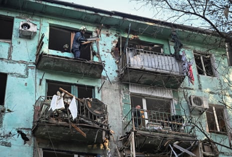 Rescuers work in an apartment building damaged by a Russian drone strike, in Zaporizhzhia, Ukraine, on Wednesday.