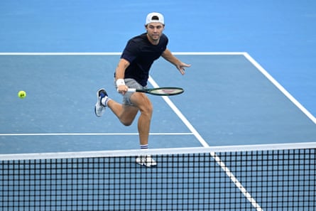 Aleksandar Kovacevic plays a shot at the net