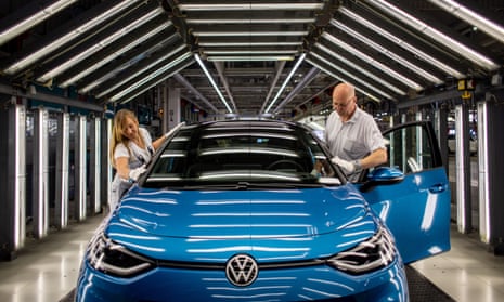 Volkswagen staff complete a quality control inspection on a blue electric ID.3 car production line at VW’s Zwickau plant.