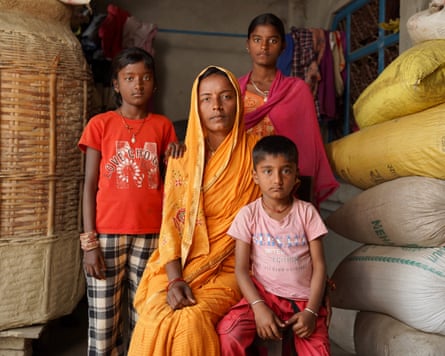 Babita Sah at her home in the district of Siraha, Nepal, with three of her four children