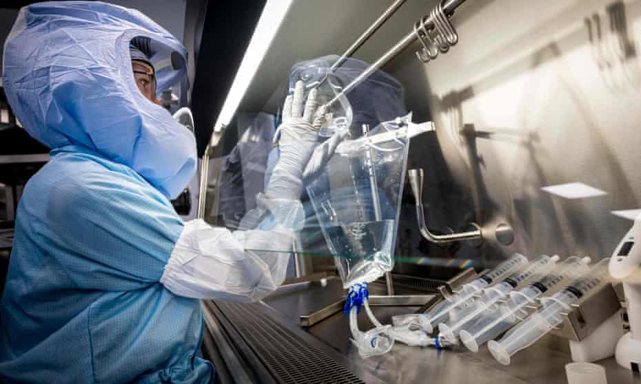 Employees in cleanroom suits test the procedures for manufacturing the Covid-19 vaccine