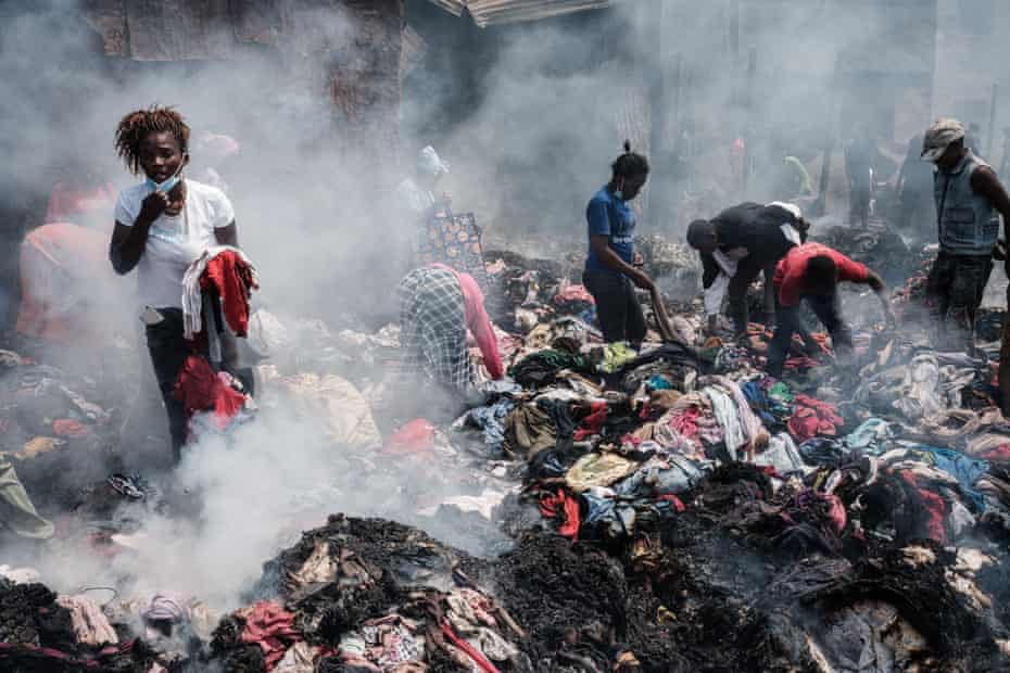 Traders scavenge clothes from debris burnt down by the fire in the early morning at Gikomba market, East Africa’s largest second hand clothing market, in Nairobi, Kenya, on November 8. A court has ordered a part of the market to be evicted to build a health centre but many traders are against the decision, according to residents