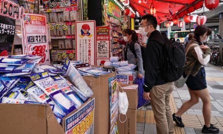 Masks and hand sanitiser on sale at a street stall in Tokyo.