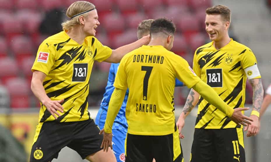 Dortmund’s Marco Reus (right) celebrates with teammates Erling Haaland (left) and Jadon Sancho.