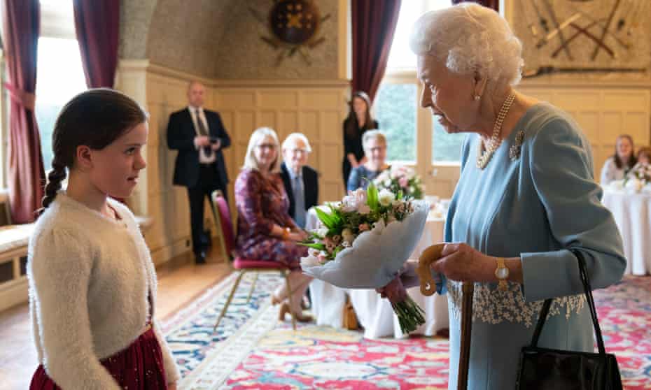 The Queen receiving a posy from Harriet Reeve, nine, during a reception in Sandringham House in Norfolk in February 2022.