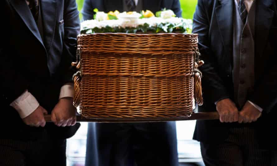 A wicker coffin carried by bearers.