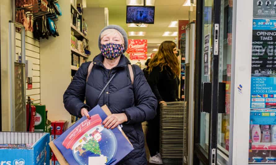 A woman is wearing a mask while shopping for Christmas.