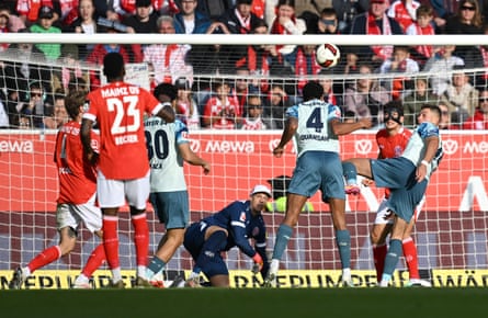 Jarell Quansah heads the ball towards goal as other players watch