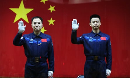 Chinese taikonauts Jin Haipeng, left, and Chen Dong wave during a ‘meet the media’ session at the Jiuquan satellite launch center in Jiuquan, Gansu province, China, on Sunday.