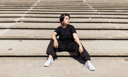 A young woman sits on some steps