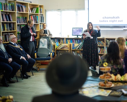 Men sitting at side, Ciffer Klein standing and speaking, and women sitting next to sandwiches