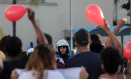 A policeman is seen in front of the protest carried out near the cemetery before the funeral of João Pedro on 14 May.