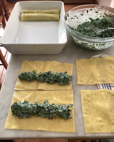 rolling the spinach filling in the pasta sheets.
