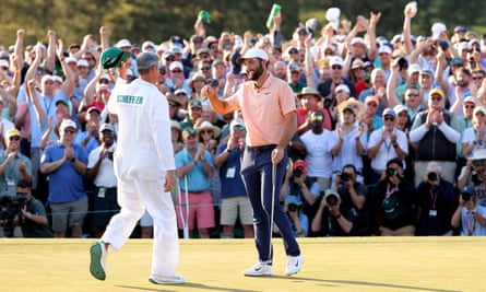 Scottie Scheffler celebrates winning the Masters for the second time with his caddie Ted Scott.
