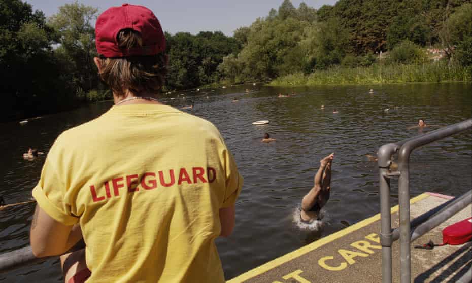 A lifeguard watches women swimming in the ladies’ pond on Hampstead Heath.