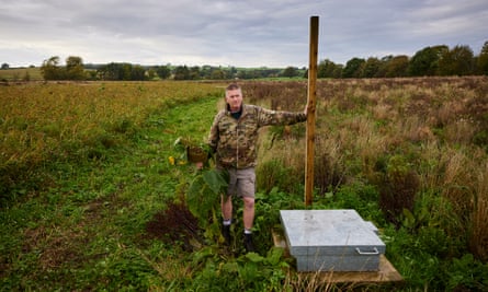 Edward Cavenagh-Mainwaring leans on a wooden post that denotes the centreline of the proposed HS2 tracks.