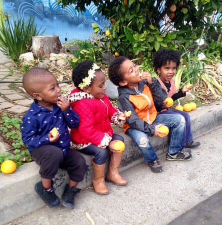 Local children enjoying the oranges grown in Ron Finley’s garden.