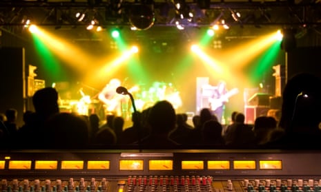 Front of house soundboard with band on stage
