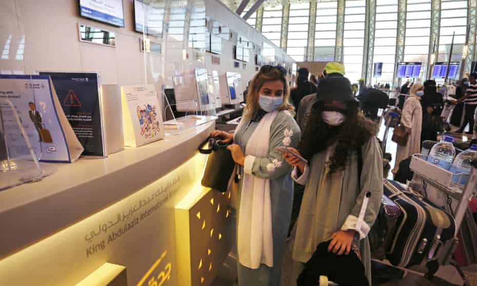 Passengers checks their baggage before boarding a flight at King Abdulaziz International airport in Jiddah, Saudi Arabia