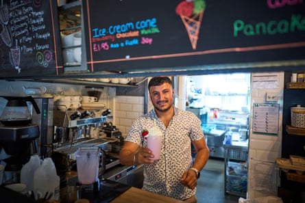 Veysel Hazar holding up a strawberry drink