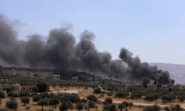 Smoke rises from buildings that were hit by reported Russian air strikes in the rebel-hold town of Muhambal, about 30 kilometres southwest of Idlib