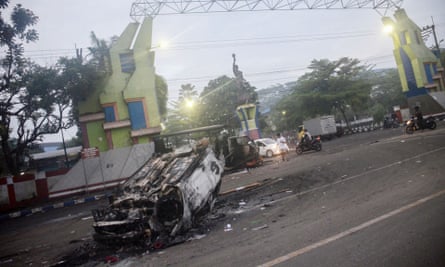 A torched car outside the Kanjuruhan stadium after the violence