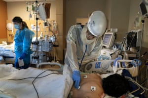 A doctor examines a Covid-19 patient at Providence Holy Cross Medical Center in Los Angeles