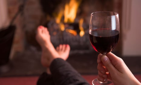 Drinking wine in front of a fire