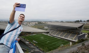 A Slovan Bratislava fan takes a selfie from on top of the rock.