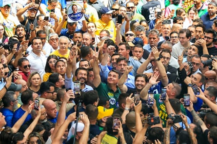 Brazil’s right-wing senator and presidential candidate Flavio Bolsonaro, of the Liberal Party (PL), waves at supporters during a campaign rally at the Sao Paulo Municipal Market in Sao Paulo