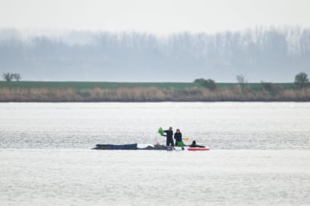 People pouring water on the whale stranded on a sandbank this month.