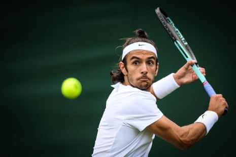 Italy's Lorenzo Musetti eyes the ball as he returns it to Peru's Juan Pablo Varillas