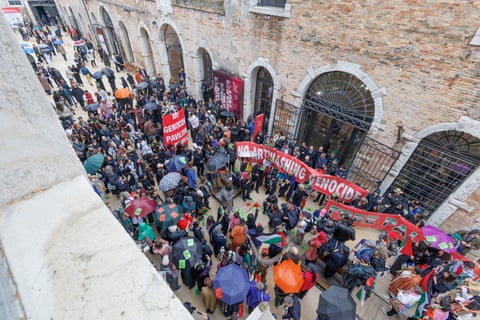 Demonstrators gather outside a building in Venice