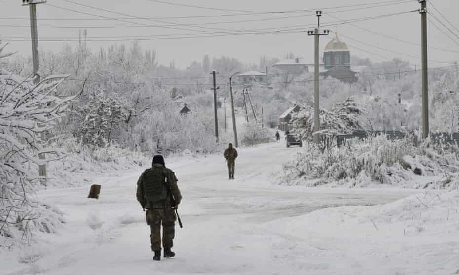 Ukrainian servicemen patrol Verkhnotoretske village near the frontline with with Russia-backed separatists in Yasynuvata district of Donetsk region, eastern Ukraine, Monday, Dec. 27, 2021