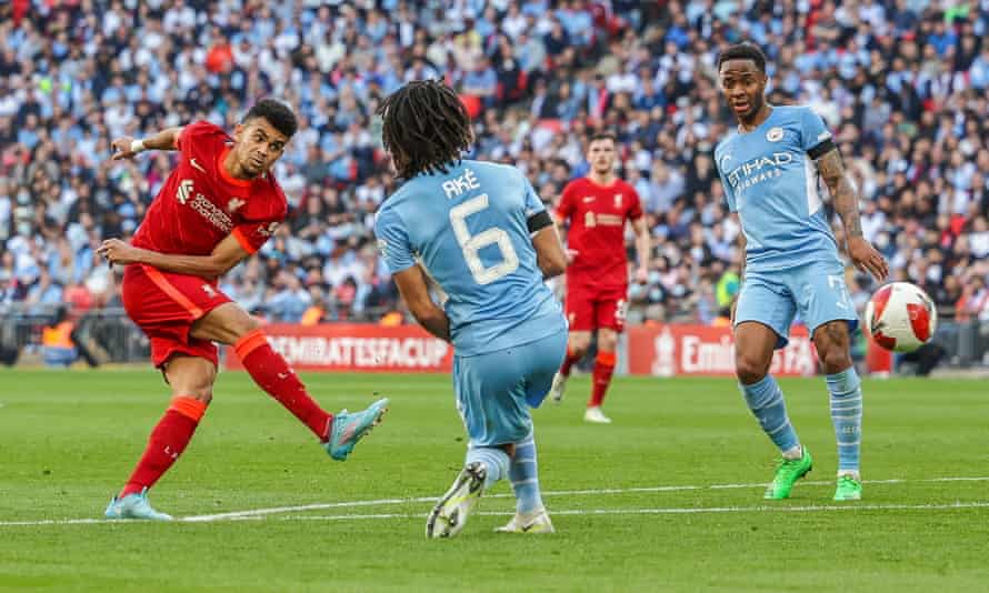 Luis Díaz shoots at Wembley as City’s Nathan Aké and Raheem Sterling try to close him down.