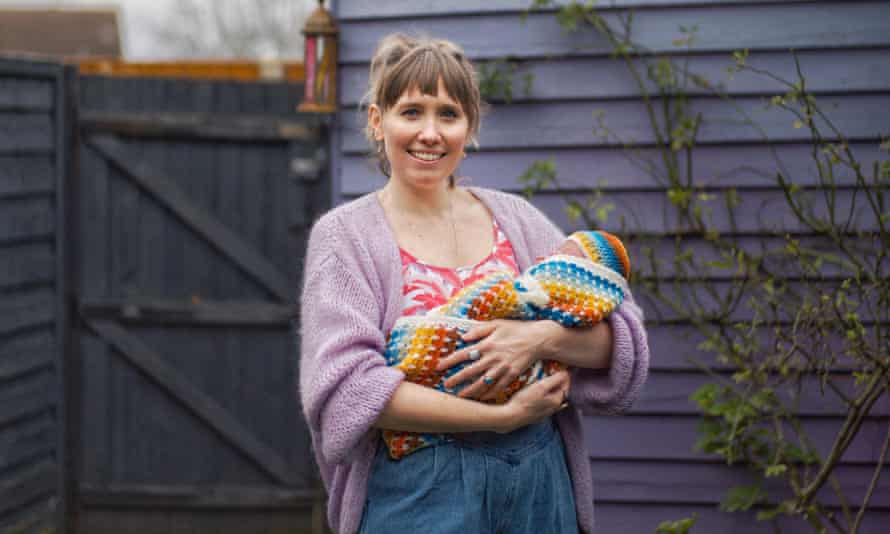 Kate Ross and four-day-old Winnifred in the garden of their home.