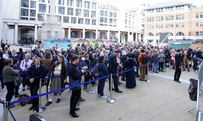 People line up before a service at Paternoster Square in London.