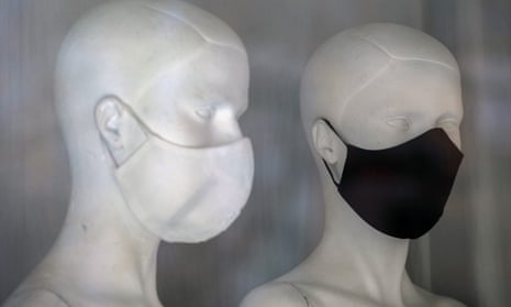 mannequins wear anti-virus masks in a shop window