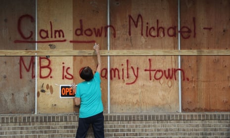 BESTPIX Florida Panhandle Region Residents Prepare For Hurricane Michael<br>MEXICO BEACH, FL - OCTOBER 09: Carol Cathey spray paints the words “Calm down Michael” on the plywood over her daughter’s business in preparation for the arrival of Hurricane Michael on October 9, 2018 in Mexico Beach, Florida. The hurricane is forecast to hit the Florida Panhandle at a possible category 3 storm. (Photo by Joe Raedle/Getty Images) *** BESTPIX ***