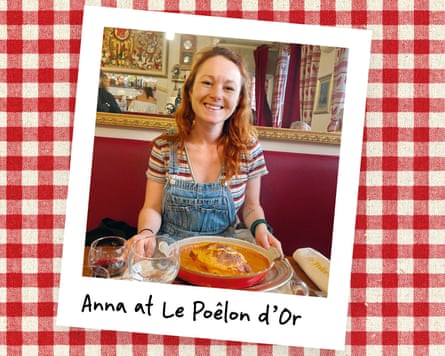 An instant photo of a woman in a restaurant with a big dish of food in front of her, against a red gingham background.