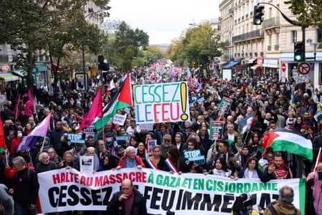 People hold a placard in a demonstration demanding an immediate ceasefire in Gaza and in support of Palestinians in Gaza, as the conflict between Israel and Palestinian Islamist group Hamas continues, in Paris, France, November 11, 2023. Placard reads: "Cease fire!".